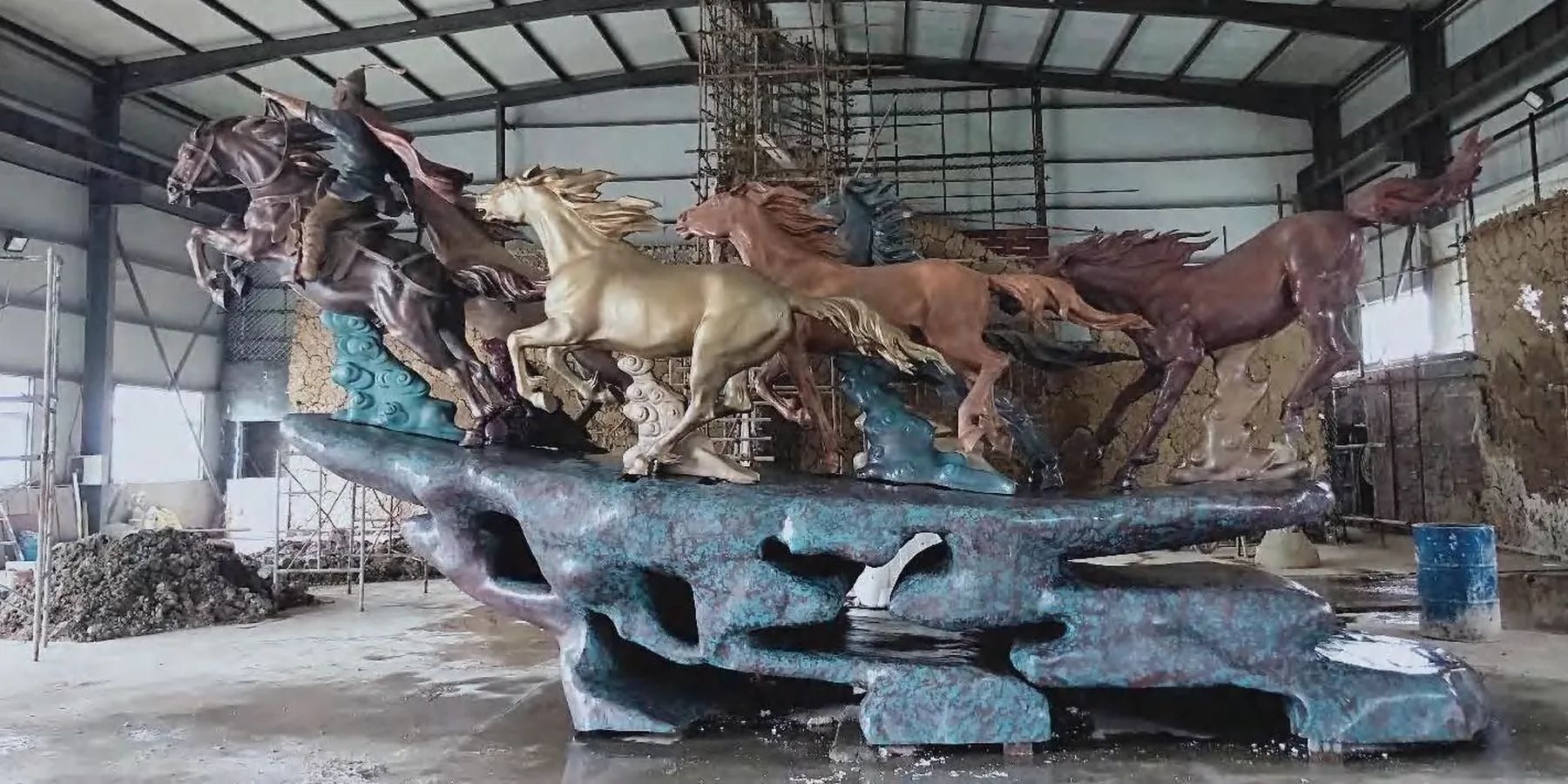 Horse-group sculpture photographed inside a workshop